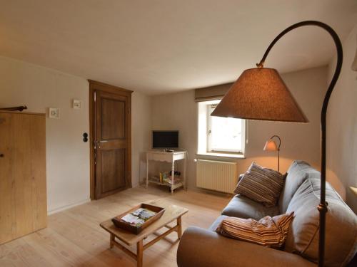 a living room with a couch and a lamp at Holiday Home in Bullange with Sauna in Bullange