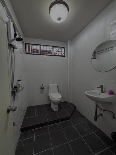 a bathroom with a toilet and a sink at Mango Rooms & Rooftop in Bangkok