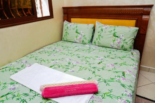 a bed with a book sitting on top of it at Secure Calm Apartment in Casablanca