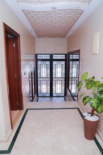a room with a potted plant in the middle at Secure Calm Apartment in Casablanca