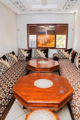 a living room with a couch and two tables at Secure Calm Apartment in Casablanca