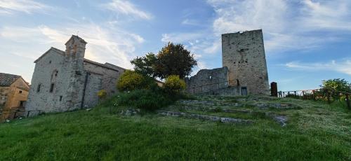 an old castle on top of a grassy hill at Casa Nonna Maria in Petrella Guidi