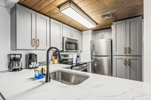 a kitchen with a sink and a stainless steel refrigerator at Cozy Bear in Gatlinburg