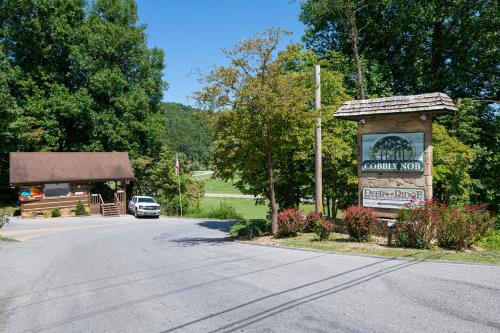 a sign for a country motel next to a road at Cozy Bear in Gatlinburg