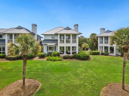 a large house with palm trees in the yard at Days To Remember villa by Peace Vacations in Georgetown