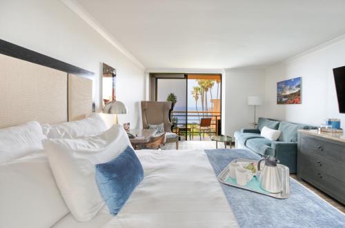 a living room with a bed and a couch at The Cliffs Hotel and Spa in Pismo Beach