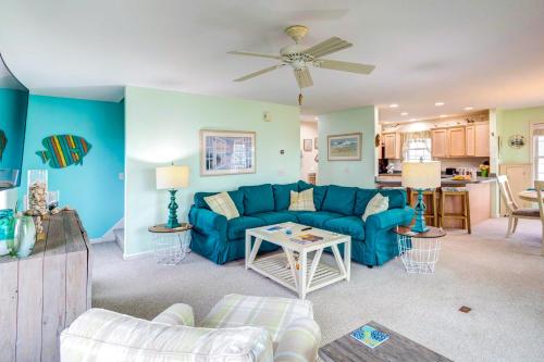 a living room with a blue couch and a table at Bowers Beach Vacation Rental 2 Blocks Away! in Frederica