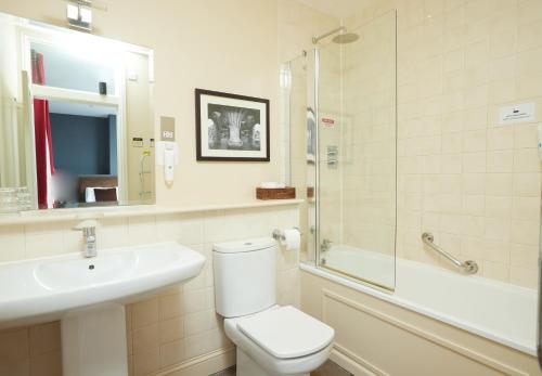 a bathroom with a toilet and a sink and a shower at Trents by Greene King Inns in Chichester