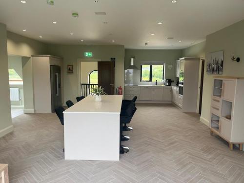 a large kitchen with a white island in a room at Ocean Breeze in Dunfanaghy
