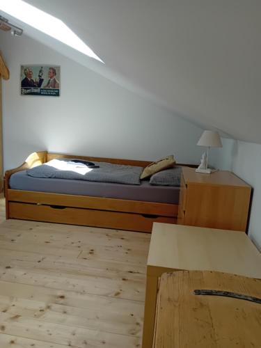 a bedroom with a bed and a table in it at Apartmán U Borovice in Rychnov nad Kněžnou