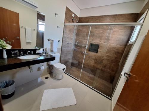 a bathroom with a shower with a toilet and a sink at Hotel Itapema in Valinhos