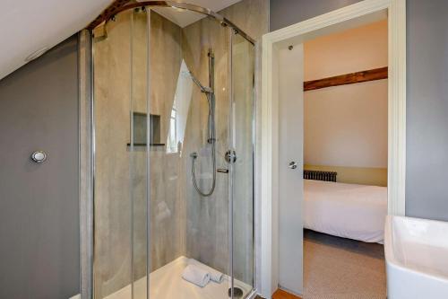 a shower with a glass door in a bathroom at Thymblethorpe - Blythview in Blyford