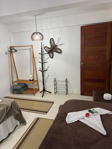 a room with a bed and a mirror at Apto Gostoso andar Cantina in São Miguel do Gostoso