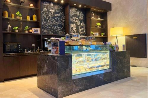 a counter in a restaurant with a display case at Radisson Blu Plaza Bangkok in Bangkok
