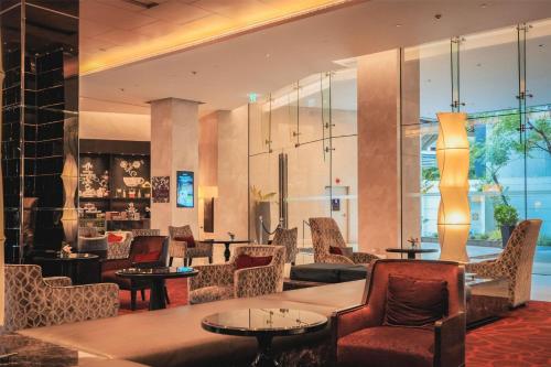 a lobby of a hotel with chairs and tables at Radisson Blu Plaza Bangkok in Bangkok