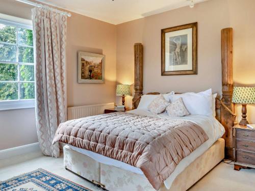 a bedroom with a large bed and a window at 5 Bed in Fitzhead 95570 in Fitzhead