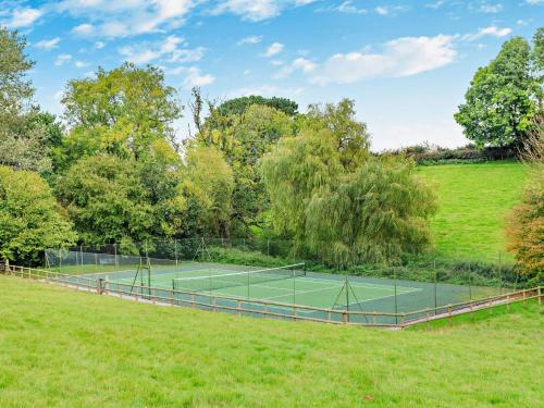 a tennis court in the middle of a field at 5 Bed in Fitzhead 95570 in Fitzhead