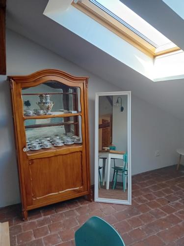 a room with a wooden cabinet and a mirror at Apartmán U Borovice in Rychnov nad Kněžnou