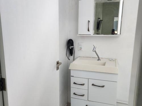 a white bathroom with a sink and a mirror at FRANCIS HOTEL MAR in Caraguatatuba