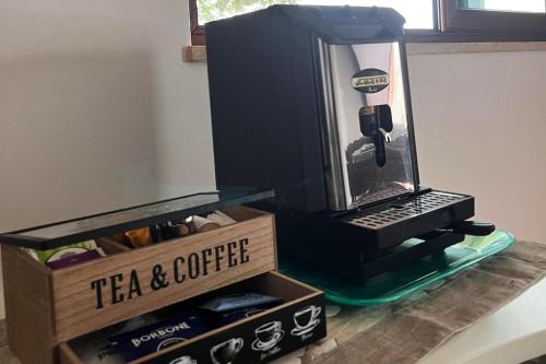 a desk with a laptop and a tea and coffeeriter at La Quercia in Borgo Partenope