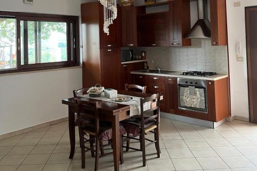 a kitchen with a table and chairs and a stove at La Quercia in Borgo Partenope
