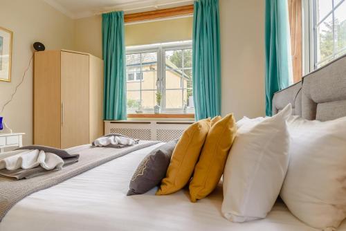 a large white bed with pillows and a window at The Avocet in Sizewell