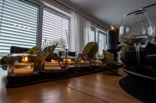 a dining room table with candles and a wine glass at Ferienwohnung Felicitas in Aichstetten