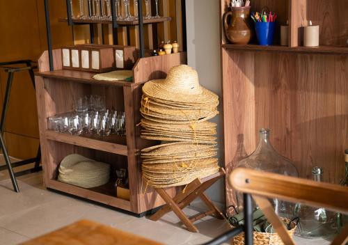 a room with a shelf with straw hats and glasses at Shakaryan Rancho&Restaurant in Dsegh