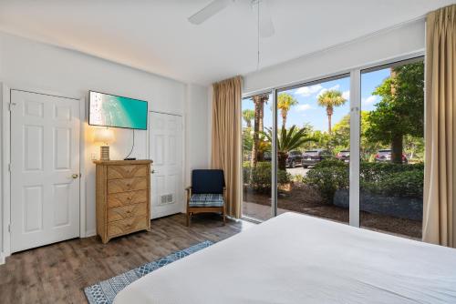 a bedroom with a bed and a sliding glass door at High Pointe Resort 131 in Inlet Beach