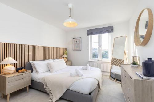 a bedroom with two beds and a mirror at Cosy 2-Bed Apartment in Tivoli in Cheltenham