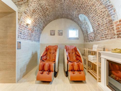 two orange life rafts sitting in a room with a fireplace at Castle with wellness and zipline in Gesves