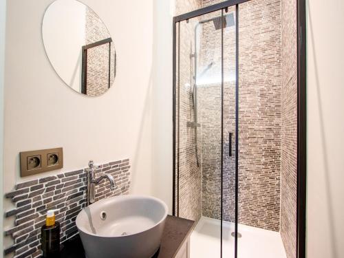 a bathroom with a tub and a glass shower at Castle with wellness and zipline in Gesves
