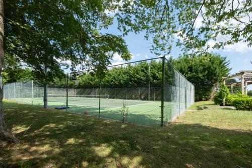ChiddinglyにあるCountryside Retreat packed with Activities Tennis including Hot Tub, BBQ, Dartsの柵付き公園内のテニスコート