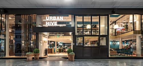 a store front with potted plants in front of it at Urban Hive Milano in Milan