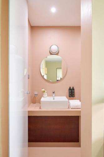 a bathroom with a sink and a mirror at Moderno Hotel Roma in Rome