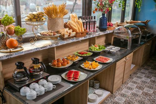 a buffet with many plates of food on a table at Glow Sapa Hotel in Sa Pa