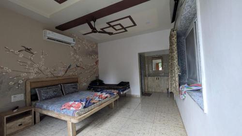 a bedroom with a bed in a room at The Gir Village Stay in Sasan Gir