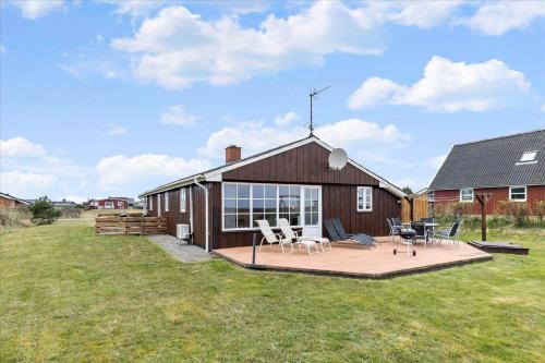 a house with a deck and chairs on it at 0065-Romo-Lakolk-165 in Lakolk
