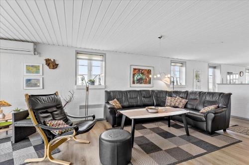 a living room with a couch and a table and chairs at 0065-Romo-Lakolk-165 in Lakolk
