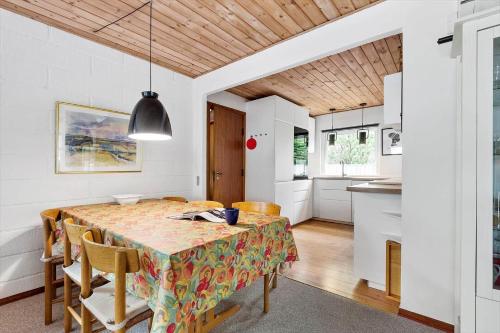 a kitchen and dining room with a table and chairs at 0413-Romo-Skovskaden-13 in Mølby
