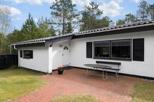 a white house with a picnic table in front of it at 0413-Romo-Skovskaden-13 in Mølby