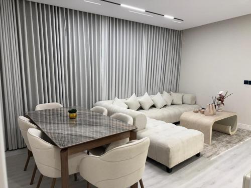 a living room with a couch and a table at شقق ViP فاخرة للعائلات in Al Ahsa