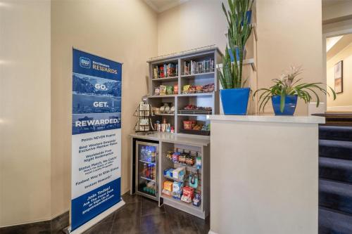 a food pantry with a shelf of food at Best Western Plus Palm Court Hotel in Davis