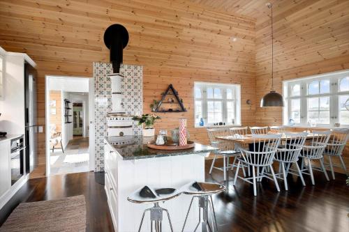 a kitchen and dining room with a table and chairs at 0090-Romo-Lakolk-256 in Lakolk