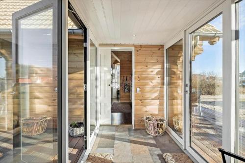 a house with sliding glass doors and wooden walls at 0090-Romo-Lakolk-256 in Lakolk