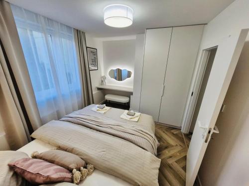 a bedroom with a large bed with a large window at Quiet place within reach of the center in Banská Bystrica
