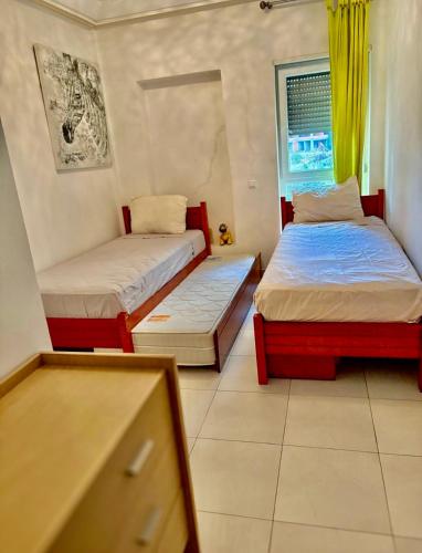a bedroom with two beds and a window at kenitra appartement premium in Kenitra
