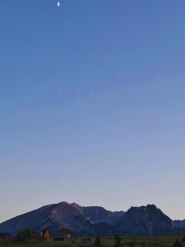 a view of a mountain range in the distance at Squirrel's House in Žabljak