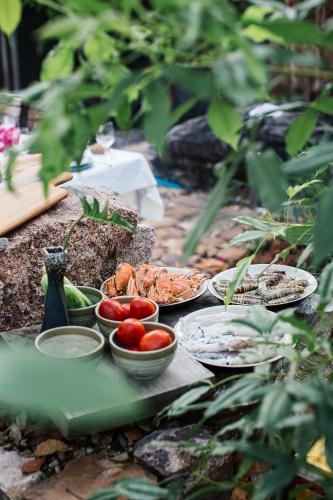 a table with bowls of food and vegetables on it at Payana Kampot in Kampot