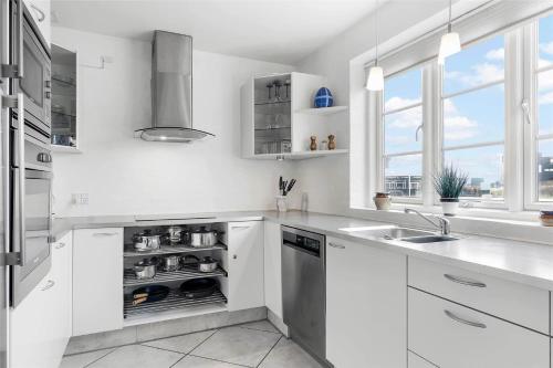 a white kitchen with white cabinets and a sink at 0372-Romo-Sonder-Frankel-8 in Havneby